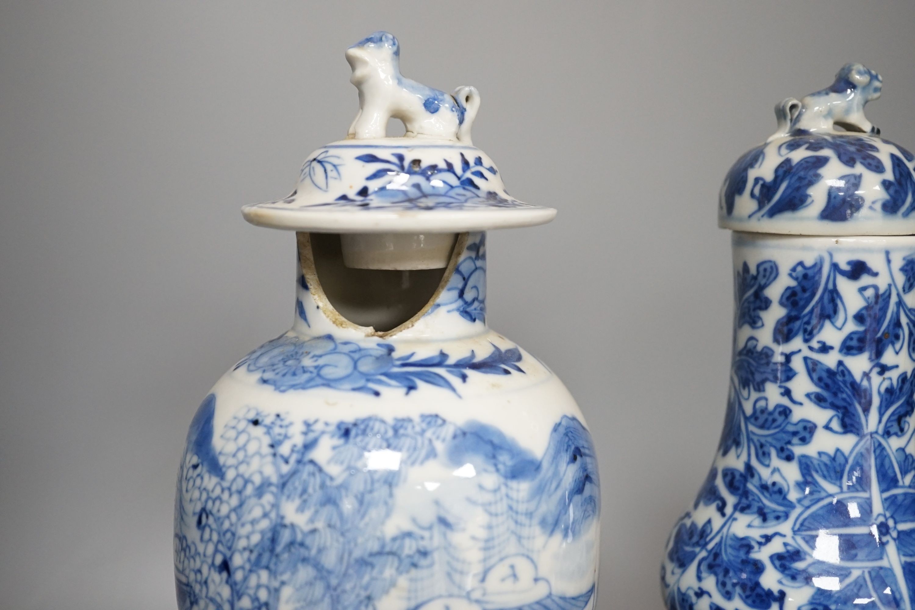 A Chinese double gourd vase and cover, a similar vase and cover and a prunus vase, all 19th century, tallest 28 cms high.